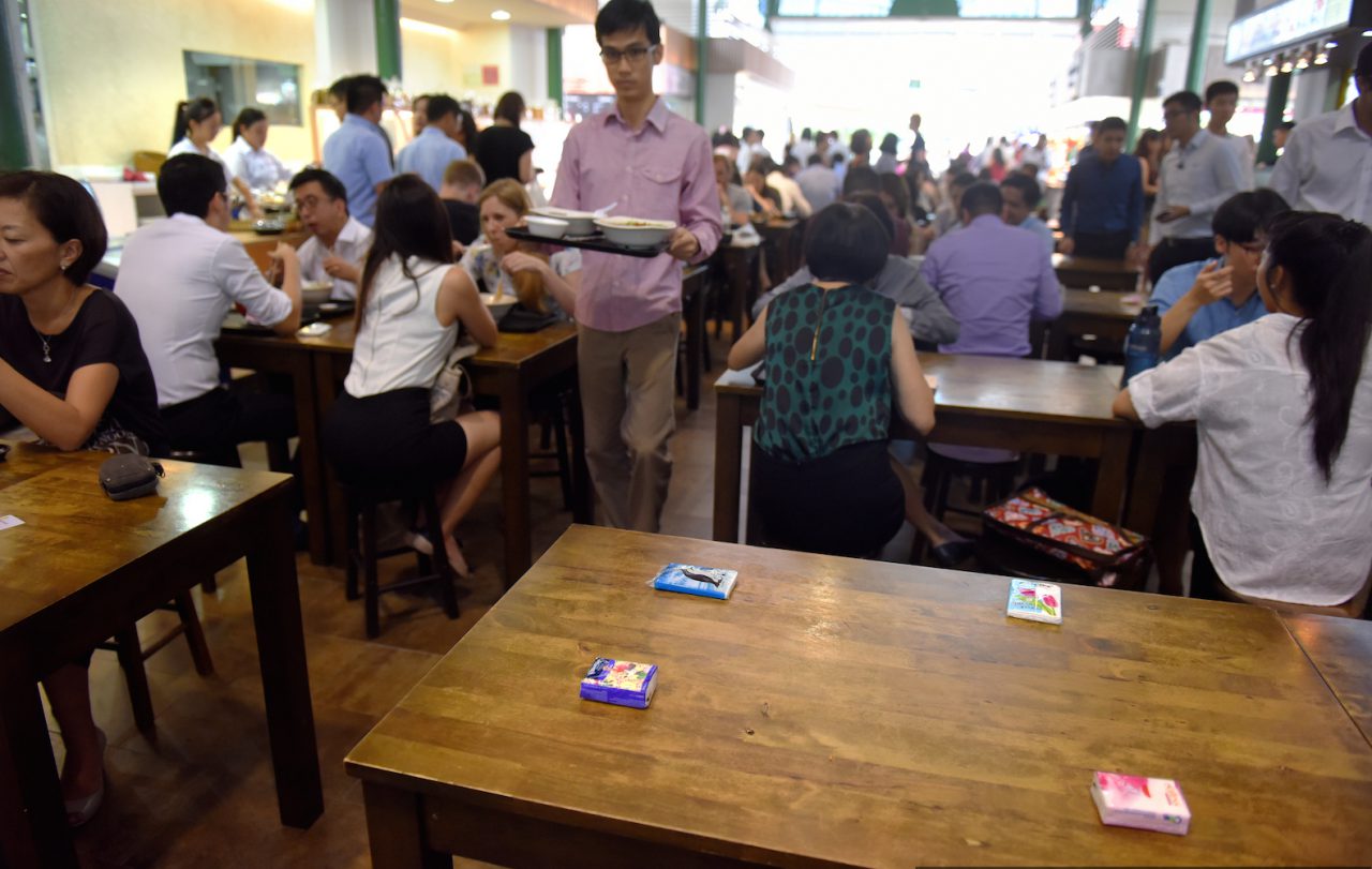 Tissue packets used to reserve a table in a Singapore eatery