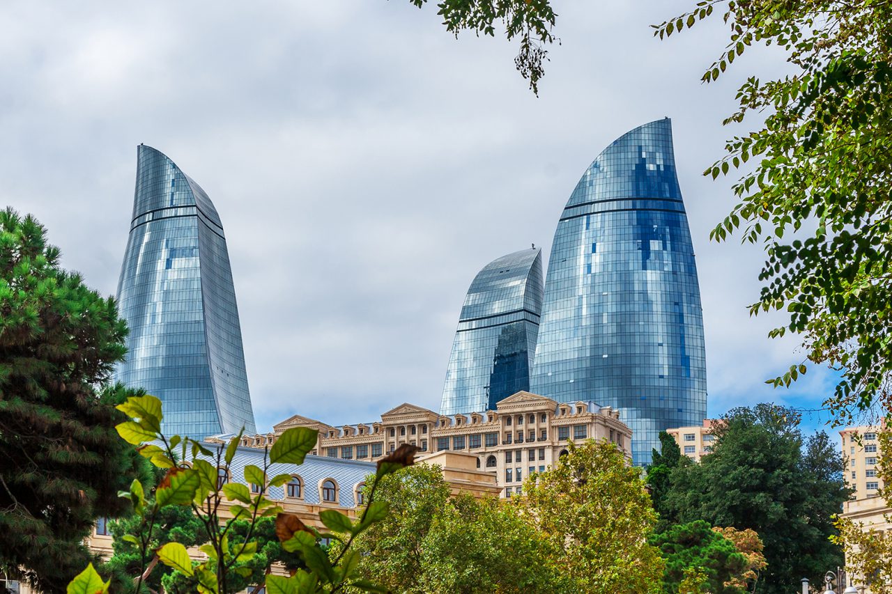 Flame towers in Baku cityscape.