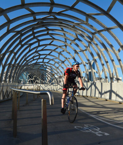 Cycling across Webb Bridge (Photo: ChameleonsEye / Shutterstock.com)