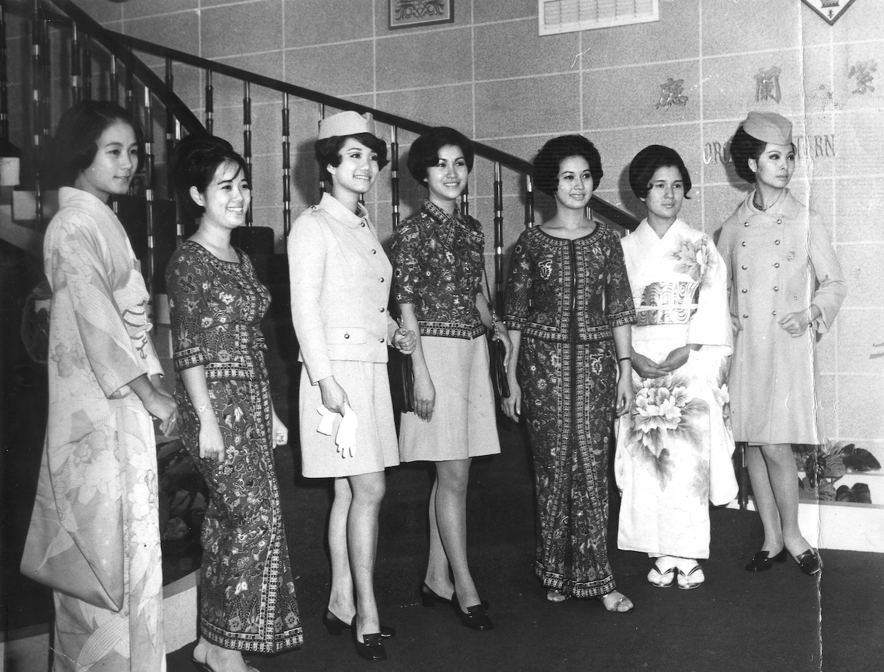 Flight attendants and ground staff posing with Japanese women