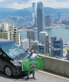 hong kong city car man with green flag