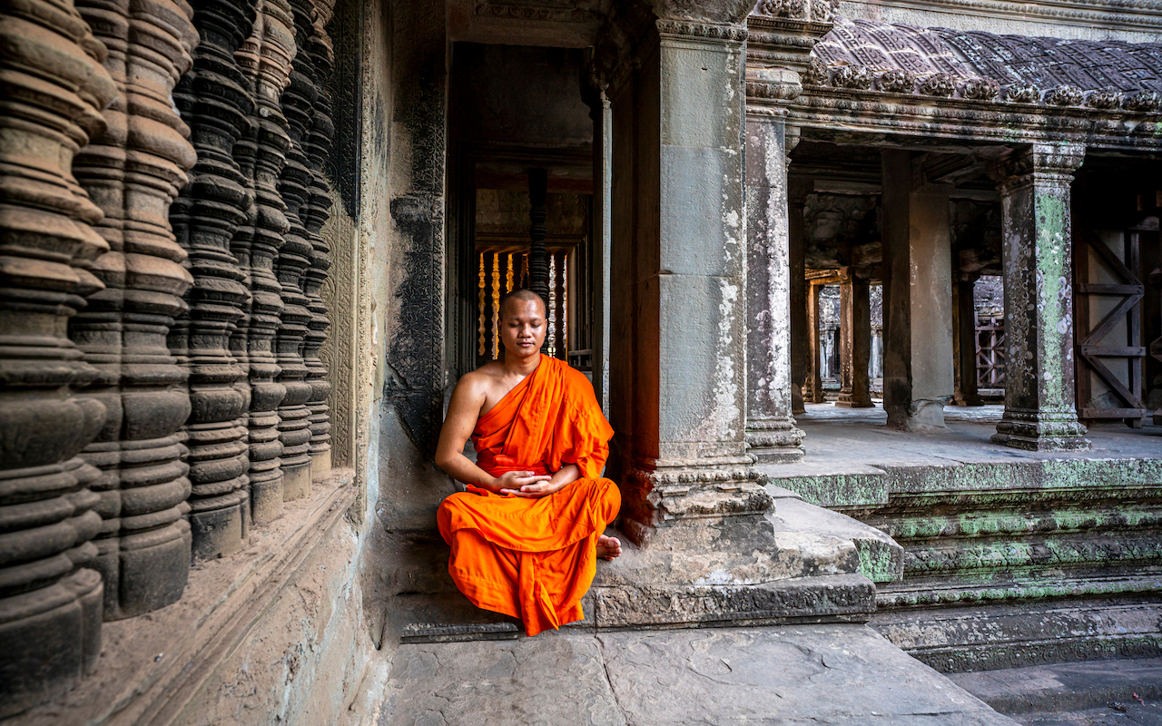 saffron-robed monk in Angkor Wat