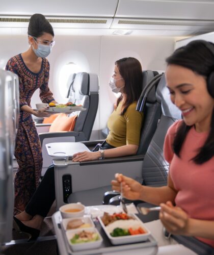 asian eating inside plane